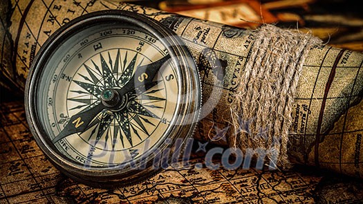 Travel geography navigation concept background - panorama of old vintage retro compass on ancient world map