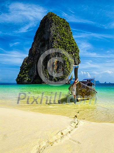 Long tail boat on tropical beach with limestone rock, Krabi, Thailand Long tail boat on tropical beach with limestone rock, Krabi, Thailand