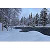 Northern river scenery in february with snow and ice