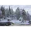 Northern river scenery in february with snow and ice