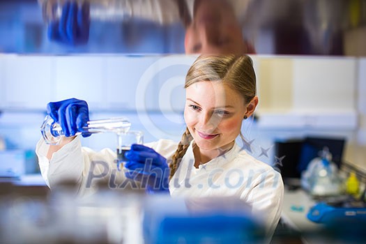 Portrait of a female researcher carrying out research in a chemistry lab (color toned image; shallow DOF)