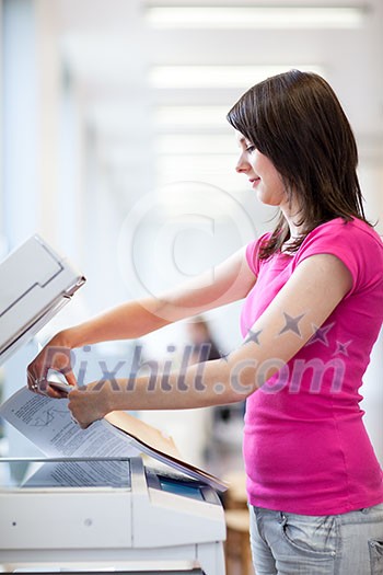 Pretty, young woman using a copy machine (shallow DOF; color toned image)