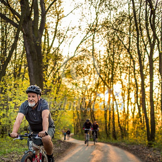Senior man on his mountain bike outdoors (shallow DOF; color toned image)