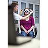 optometry concept - pretty young woman having her eyes examined by an eye doctor