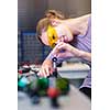 Female scientist carrying out research experiments in a quantum optics lab (color toned image)