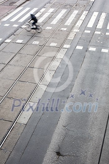 urban traffic concept - city street with a crossing, rail, motion blurred traffic