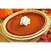 Whole pumpkin pie with fresh whipped cream