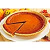 Whole pumpkin pie with a slice cut out