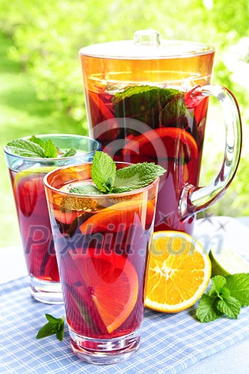 Refreshing fruit punch beverage in pitcher and glasses Refreshing fruit punch beverage in pitcher and glasses