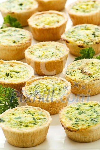 Plate of many mini bite size quiche appetizers Plate of many mini bite size quiche appetizers