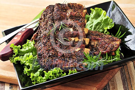 Plate of spare ribs and greens for dinner Plate of spare ribs and greens for dinner