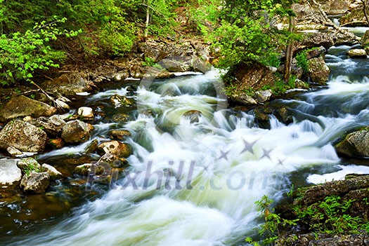 Water rushing among rocks in river rapids in Ontario Canada Water rushing among rocks in river rapids in Ontario Canada
