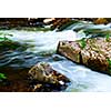 Water rushing among rocks in river rapids in Ontario Canada