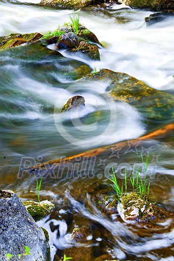 Water rushing among rocks in river rapids in Ontario Canada