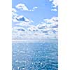 Blue ocean water and sunny sky background