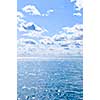 Blue ocean water and sunny sky background