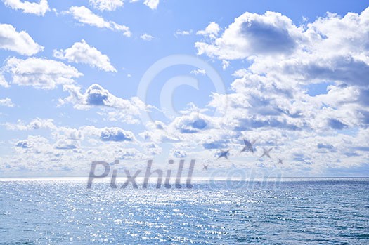 Blue ocean water and sunny sky background
