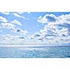 Blue ocean water and sunny sky background