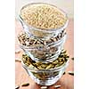Three stacked bowls of sesame sunflower and pumpkin seeds