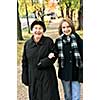 Teen granddaughter walking with grandmother in autumn park