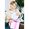 Elderly woman opening birthday card and present
