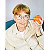Elderly woman eating healthy holding a nutritious apple