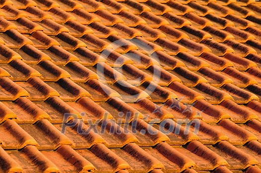 Closeup of red clay interlocking roofing tiles background Closeup of red clay interlocking roofing tiles background