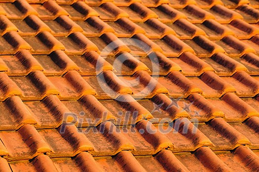 Closeup of red clay interlocking roofing tiles background Closeup of red clay interlocking roofing tiles background