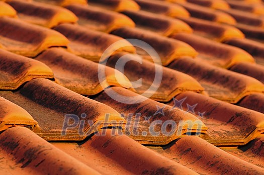 Closeup of red clay interlocking roofing tiles background Closeup of red clay interlocking roofing tiles background