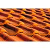 Closeup of red clay interlocking roofing tiles background