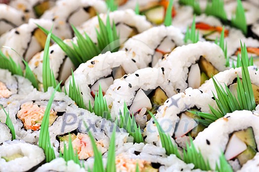 Close up on tray of assorted sushi appetizers