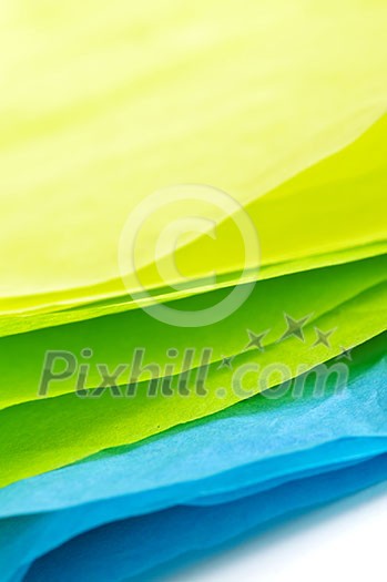 Close up of blue green and yellow tissue paper Close up of blue green and yellow tissue paper