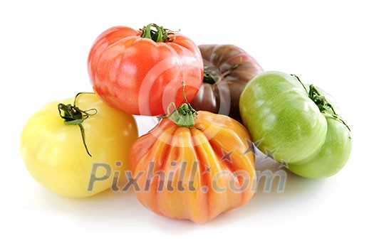 Multi colored heirloom tomatoes isolated on white background