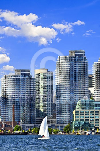 Sailboat sailing in Toronto harbour with scenic waterfront view Sailboat sailing in Toronto harbour with scenic waterfront view