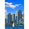 Sailboat sailing in Toronto harbour with scenic waterfront view