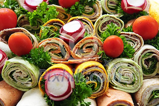 Closeup on platter of assorted meat tortilla wraps Closeup on platter of assorted meat tortilla wraps