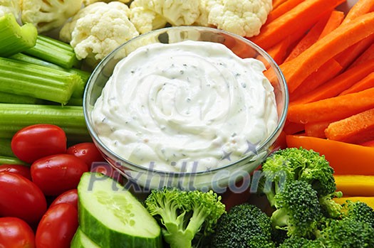 Platter of assorted fresh vegetables with dip