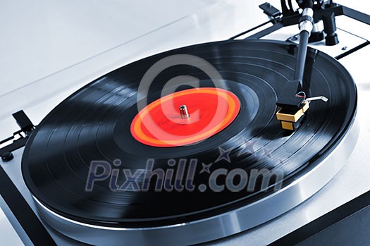 Vinyl record spinning on turntable close up