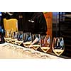 Row of white wine glasses in winery tasting event