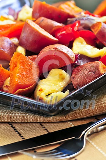 Vegetarian dish of roasted yams with cheese and peppers Vegetarian dish of roasted yams with cheese and peppers