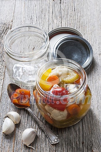 Home preserving mixed vegetables by pickling in glass canning jars