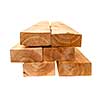 Edge of six cedar two by four lumber boards stacked on white background