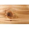 Closeup of red cedar plank showing knot texture and natural woodgrain pattern as wood background