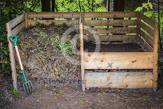 Large cedar wood compost boxes with composted soil and yard waste for backyard composting