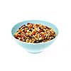 Bowl of homemade granola with various seeds and berries isolated on white background