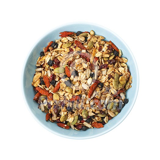 Bowl of homemade granola with various seeds and berries shot from above isolated on white background