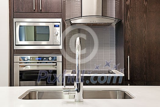 Modern luxury kitchen interior with stone countertop and stainless steel appliances Modern luxury kitchen interior with stone countertop and stainless steel appliances