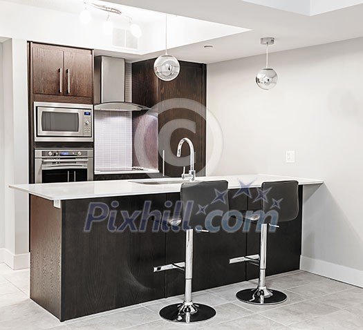 Modern luxury kitchen interior with dark wood cabinets, island counter, bar stools and stainless steel appliances Modern luxury kitchen interior with dark wood cabinets, island counter, bar stools and stainless steel appliances