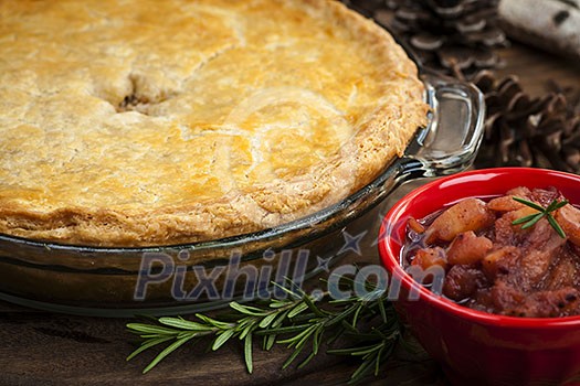 Traditional pork meat pie Tourtiere with apple and cranberry chutney from Quebec, Canada.