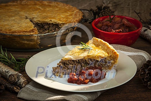 Slice of traditional pork meat pie Tourtiere with apple and cranberry chutney from Quebec, Canada. Slice of traditional pork meat pie Tourtiere with apple and cranberry chutney from Quebec, Canada.